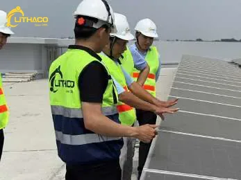 Kỹ sư LITHACO kiểm tra tấm pin cùng đoàn tham quan trên mái công trình